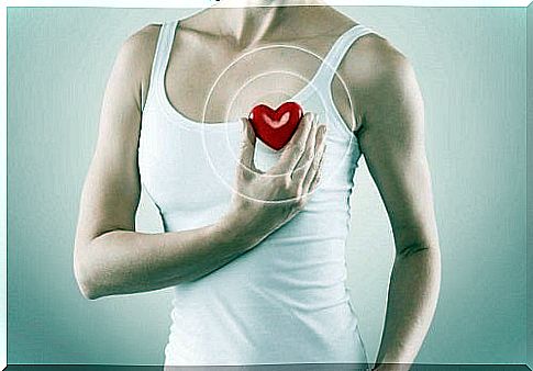 Woman holding a red heart in her hand