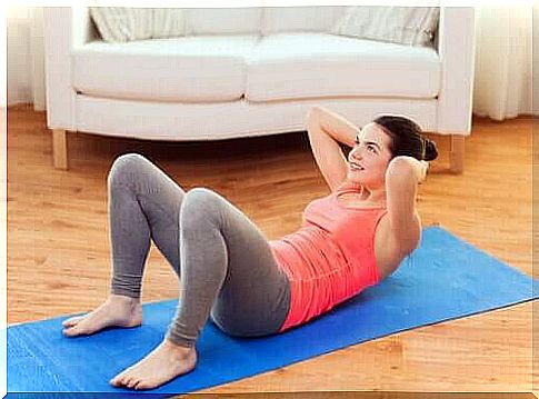 Woman training her abdominal muscles at home