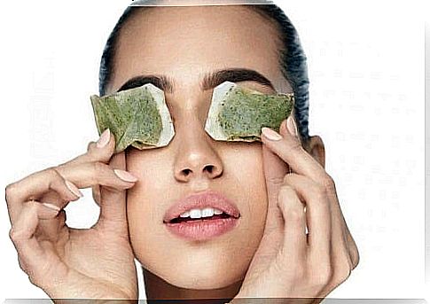 Woman using tea bags for dark circles