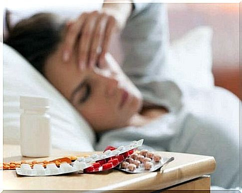 Sick woman with medicines on the nightstand