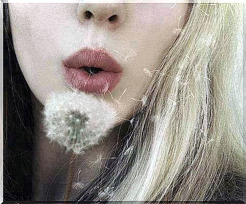 Girl playing with a dandelion